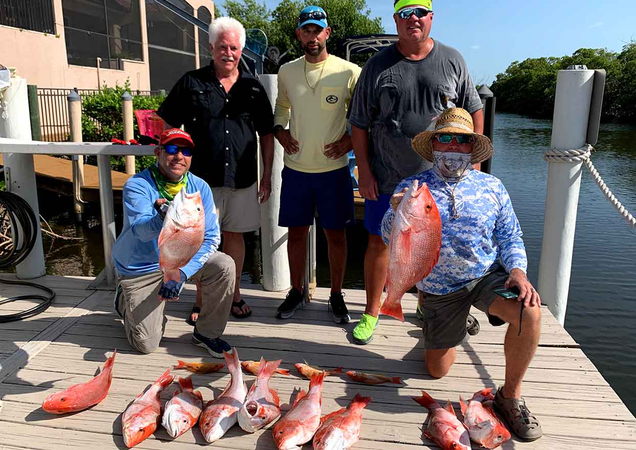 Fishermen with assorted red snapper fish caught off-shore fishing with Dahl-fins Charters
