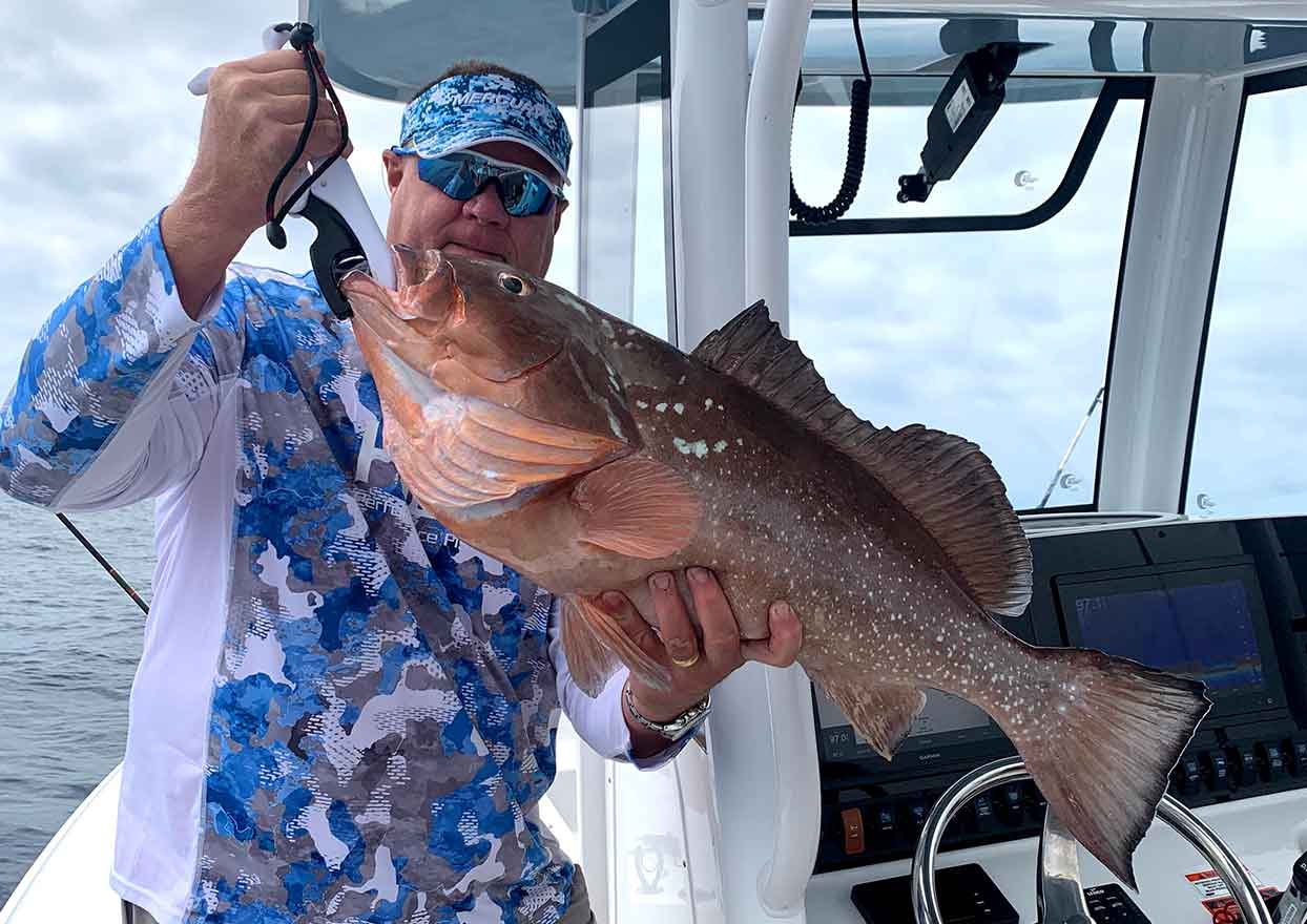 Fort myers fisherman with large fish caught aboard Dahl-Fins Charters fishing charter