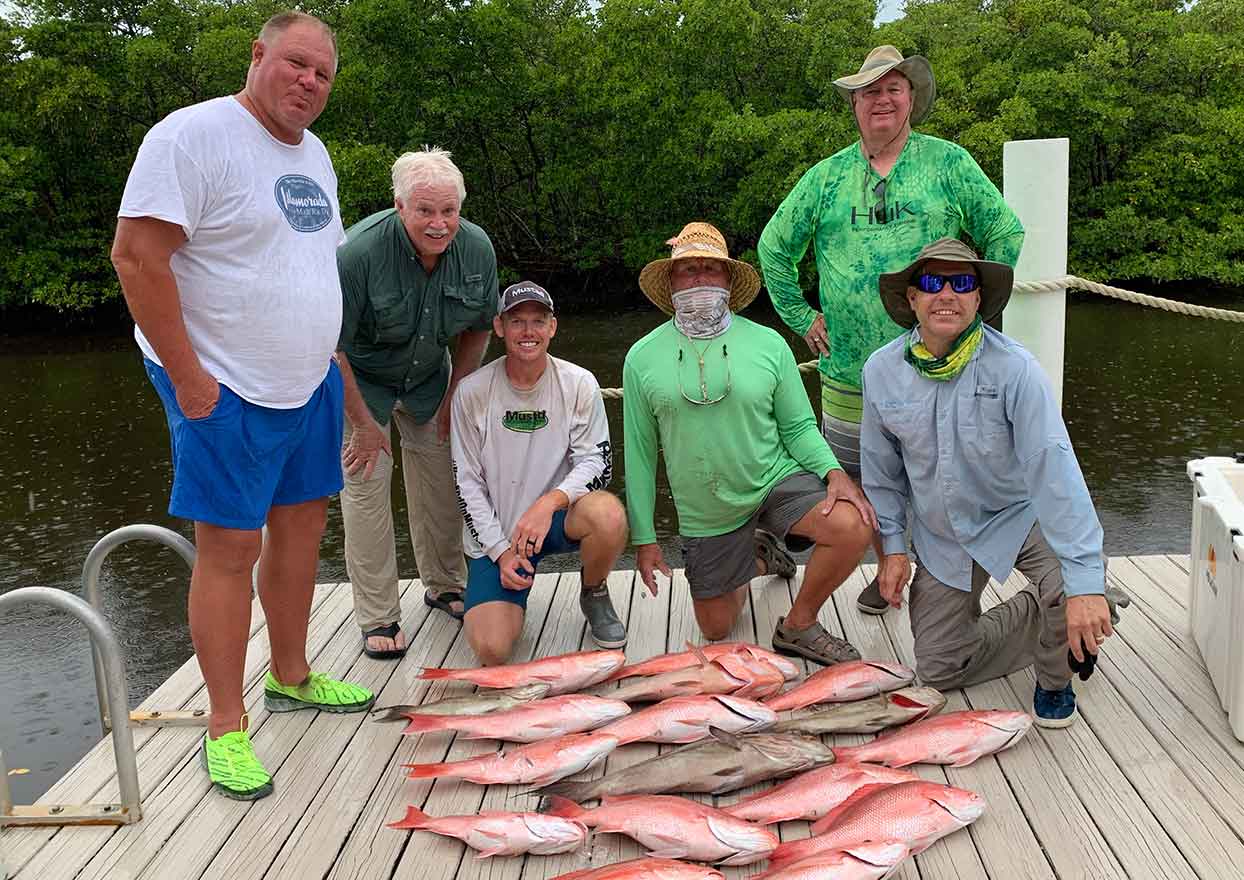 Group of fishing charter clients with red snapper fish caught in Southwest Florida