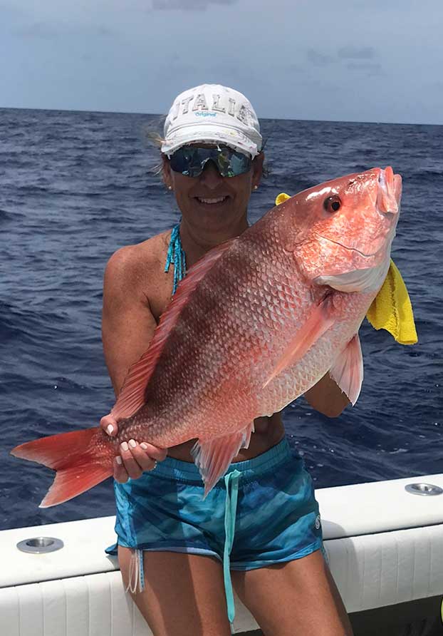 Red snapper fish held by off-shore fishing charter client